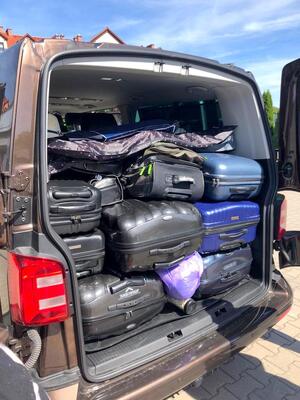 Walizki poukładane w bagażniku samochodowym.