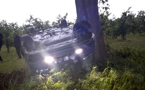 Samochód w rowie leżący na dachu.