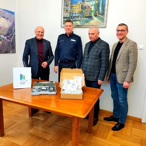 Czterech mężczyzn obok siebie, w tym trzech urzędników i Komendant przed nimi narkotest.