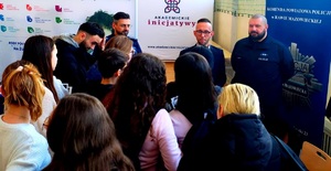 Policjanci rozmawiają z młodzieżą na targach edukacji.